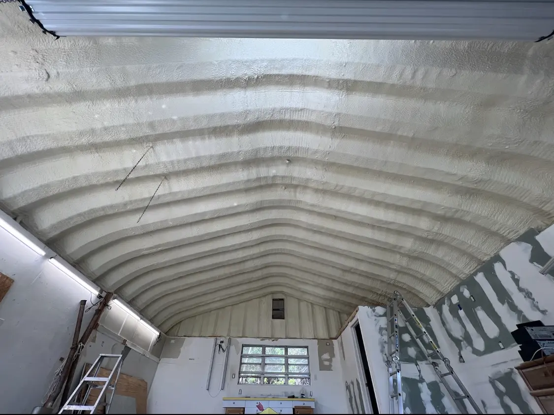 Spray polyurethane foam applied to the underside of a metal roof deck in Grandville